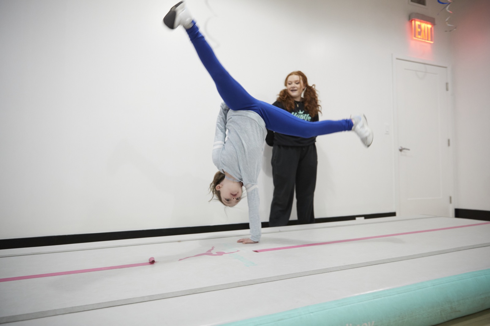 A Fastbreak coach spotting a young athlete tumbling