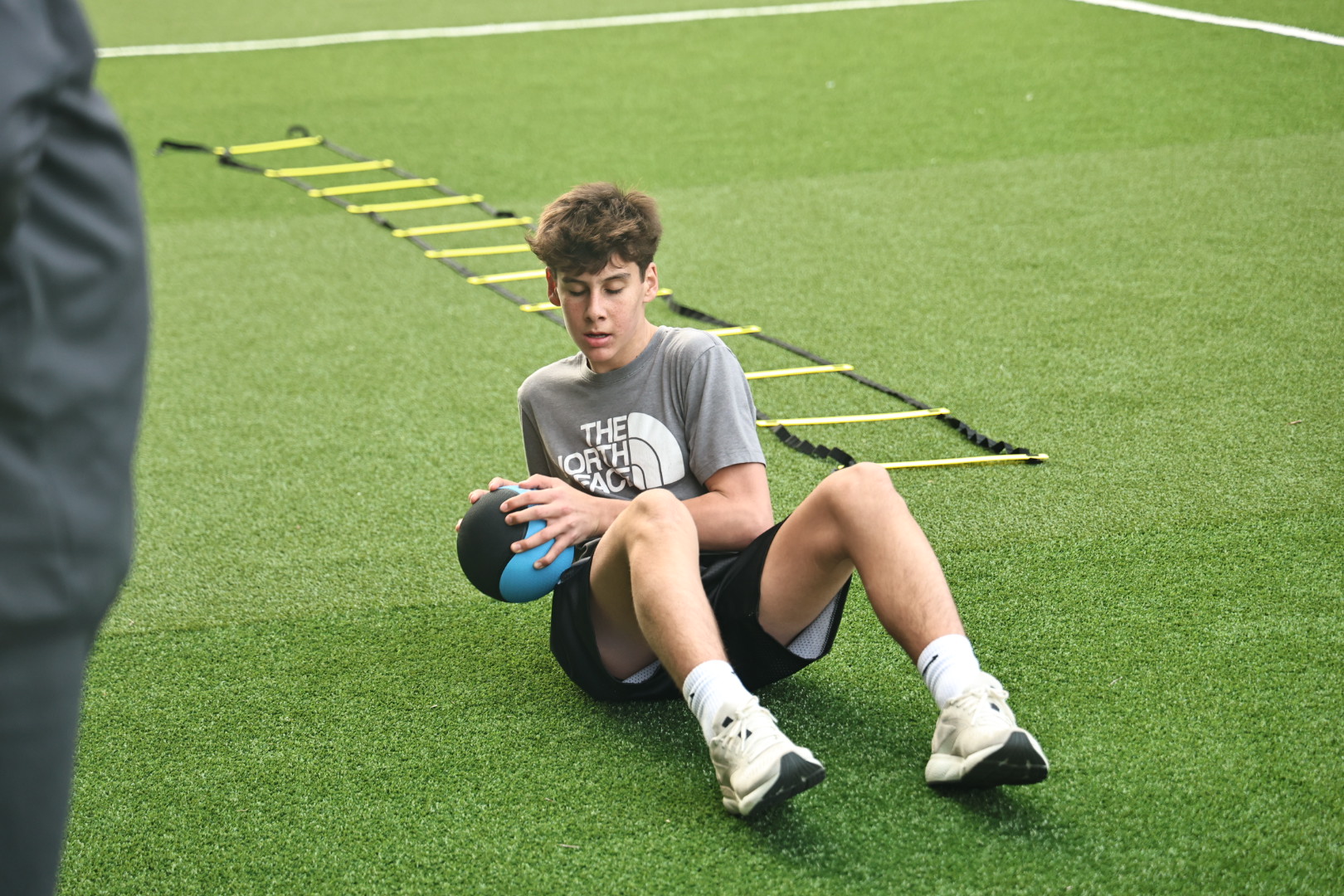 A coach working with a young athlete